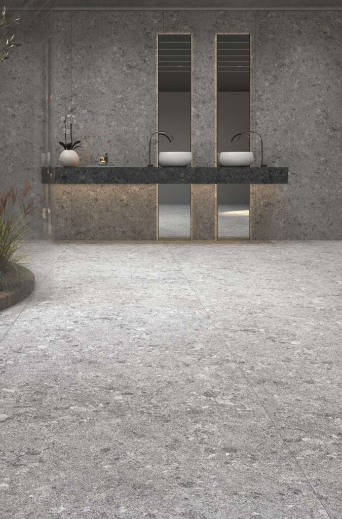 Modern bathroom with gray stone walls featuring dark gray veining